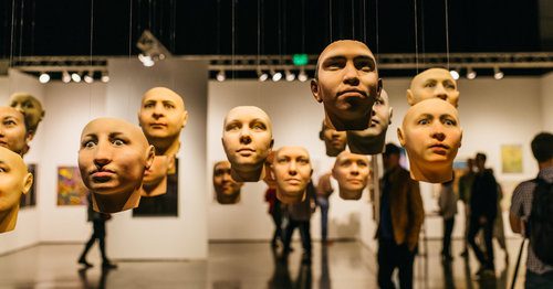 seattle art fair indoor faces statues