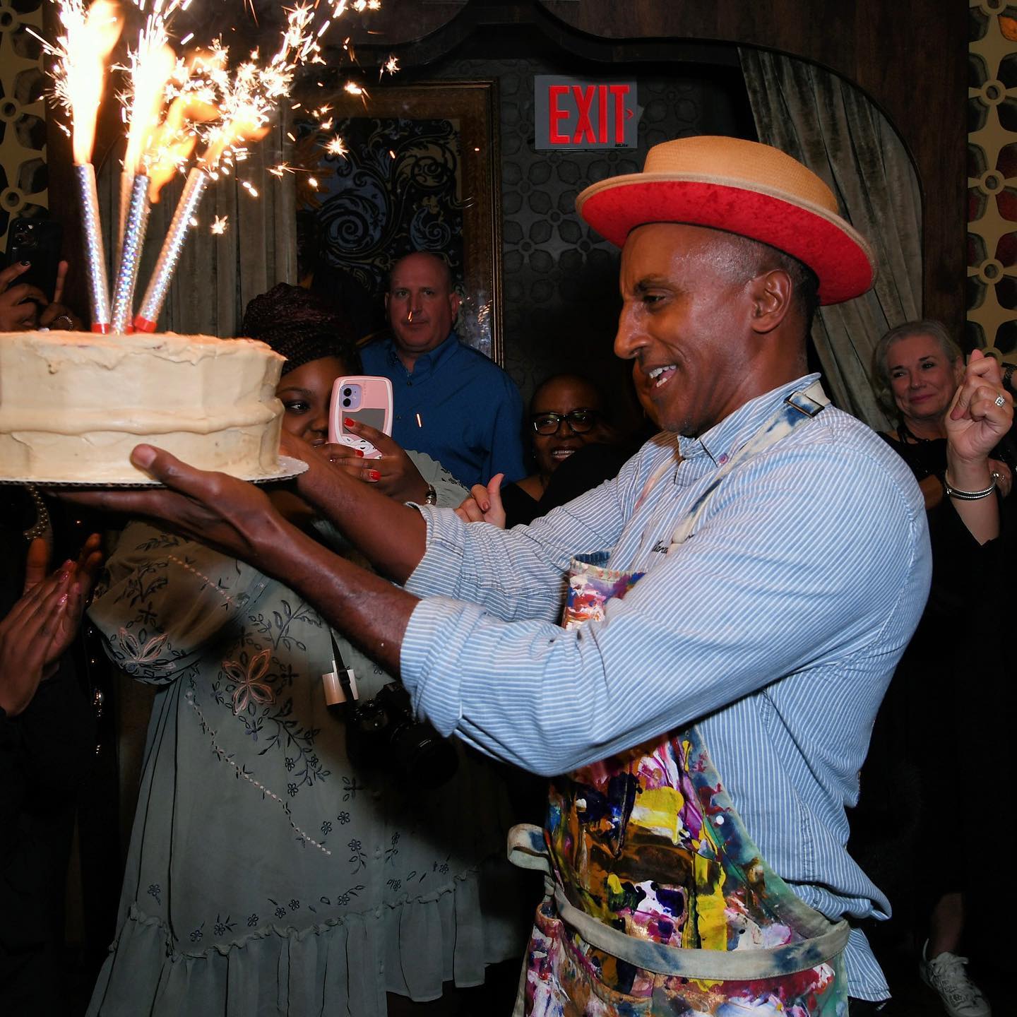 waiter lifting cake at a21's culinary event