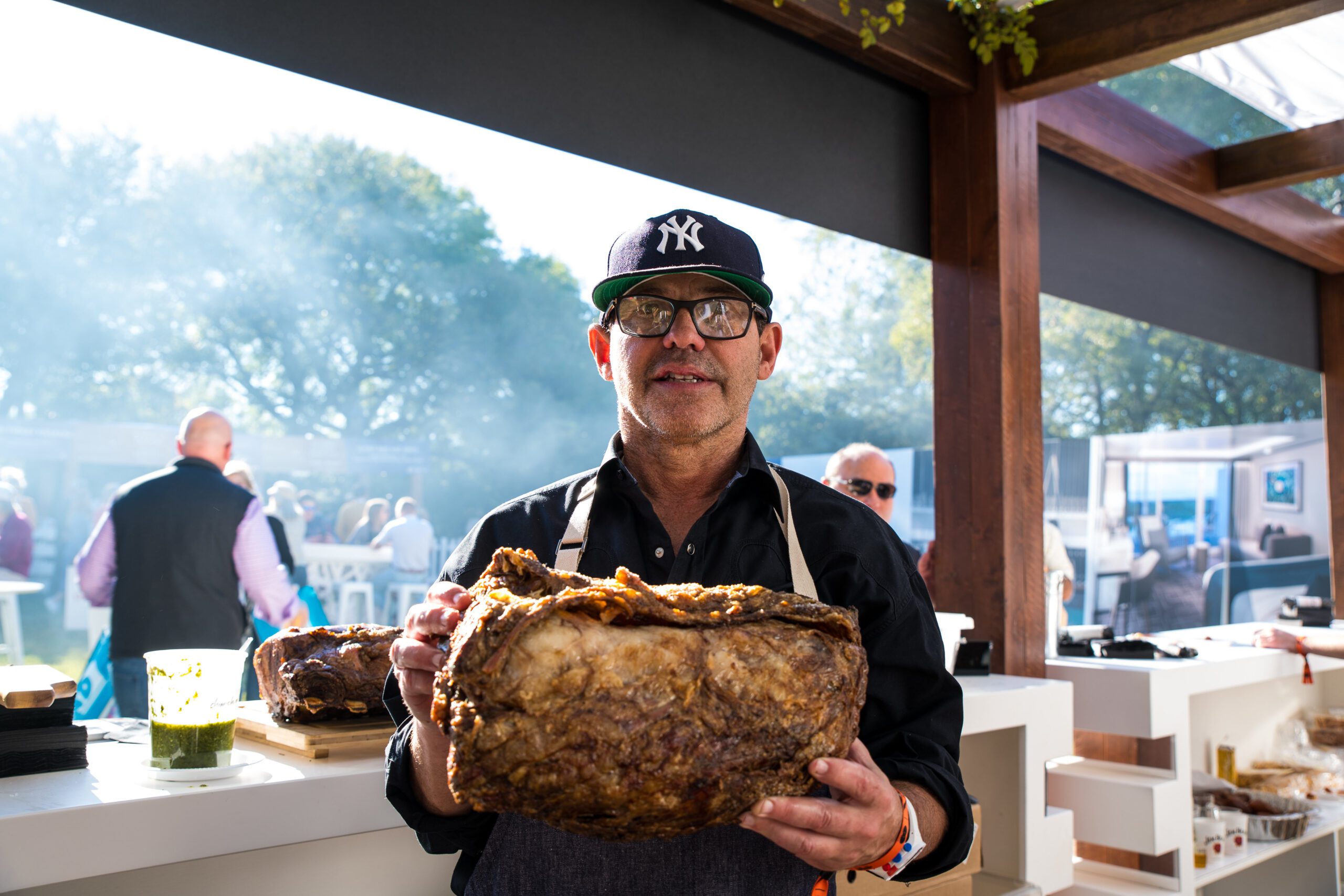 chef with meat at a21 culinary event