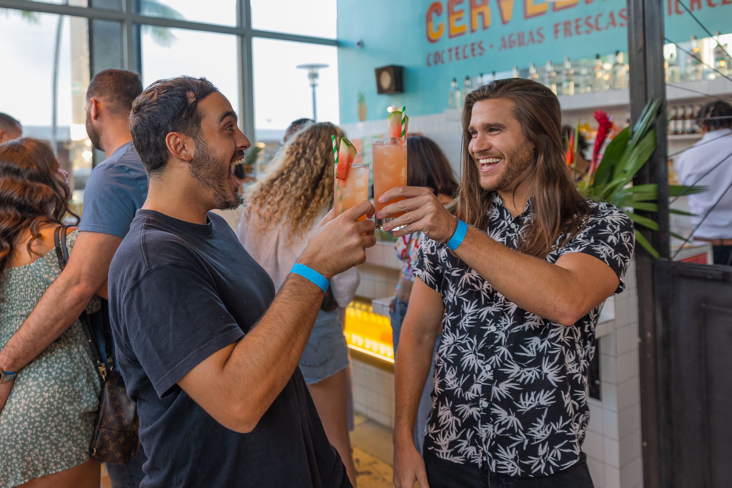 Andrew Gonzalez and Calen Santos drinking at a21 event